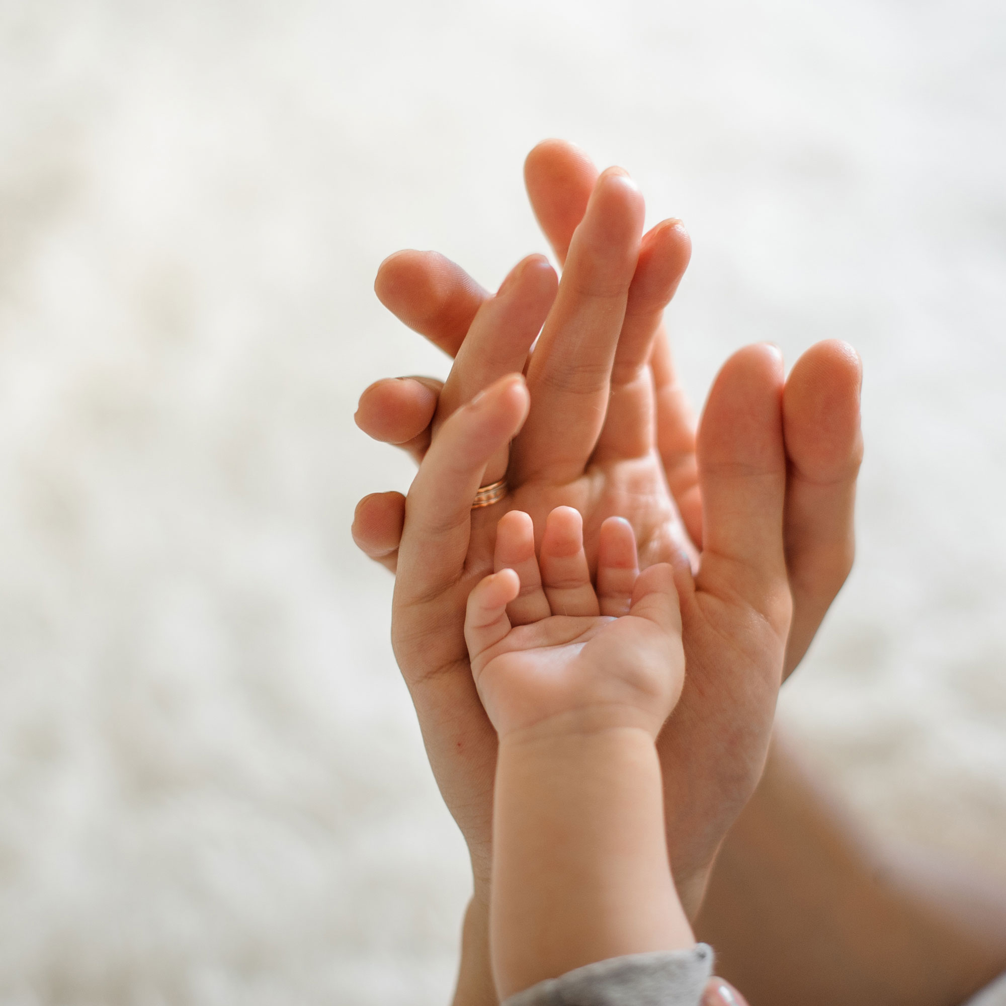 close-up-parents-baby-join-hands.jpg